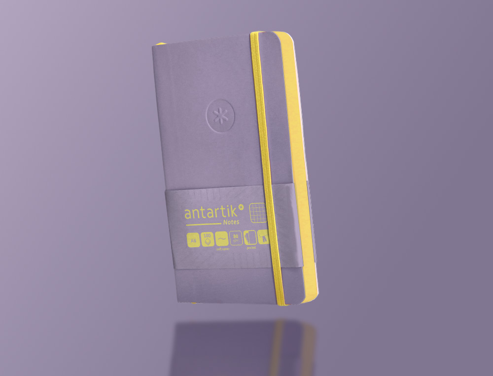 CUADERNO CON GOMILLA ANTARTIK NOTES TAPA BLANDA A6 CUADRICULA MORADO Y AMARILLO 100 HOJAS 80 GR FSC
